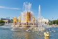 Moscow, Russia - July 22, 2019: View of water surface and golden figures of Friendship of Peoples fountain in VDNH park in Moscow