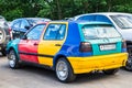 Volkswagen Golf Harlekin old car on the city parking. Parts of the car are painted in different colors Royalty Free Stock Photo