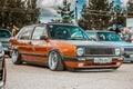 Moscow, Russia - July 06, 2019: Volkswagen Golf 2 yellow-brown in the parking lot. classic car with lowered suspension and Royalty Free Stock Photo