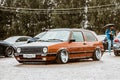 Moscow, Russia - July 06, 2019: Volkswagen Golf 2 yellow-brown in the parking lotin the rain . classic car with lowered suspension Royalty Free Stock Photo