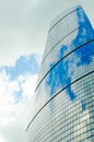 Wall of a skyscraper with mirror glass against a sky with clouds. Vertical photography. Royalty Free Stock Photo