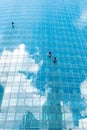 Moscow, Russia - July 12, 2020: Workers wash windows on a skyscraper. Vertical background