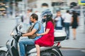 MOSCOW - RUSSIA JULY 02, 2017: young caucasian man is driving a girl on a motorcycle. The girl is dressed in a red dress Royalty Free Stock Photo