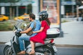 MOSCOW - RUSSIA JULY 02, 2017: young caucasian man is driving a girl on a motorcycle. The girl is dressed in a red dress Royalty Free Stock Photo