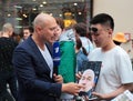 Football fan with a portrait of the coach of the Russian national team gives interview to the TV reporter on Nikolskaya street in