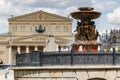 Moscow, Russia - June 02, 2019: Fountain Vitali on Revolution Square in Moscow against Bolshoi Theatre at cloudy day