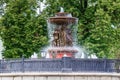 Moscow, Russia - June 02, 2019: Fountain Vitali on Revolution Square in Moscow against green trees closeup Royalty Free Stock Photo