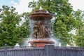 Moscow, Russia - June 02, 2019: Fountain Vitali on Revolution Square in Moscow against green trees closeup Royalty Free Stock Photo