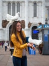 A girl with a white dove on a Moscow street in summer