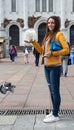 A girl with a white dove on a Moscow street in summer