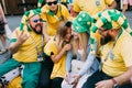 MOSCOW, RUSSIA - JUNE 2018: A group of Brazilian football fans laughing with Russian girls on the street during the