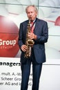 MOSCOW, RUSSIA - JUNE 19, 2012: Head of Scheer Management company August-Wilhelm Scheer play jazz theme the saxophone at Mission