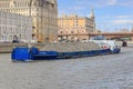 Moscow, Russia - June 21, 2018: Loaded barge floating against Moskva river embankment on a sunny summer day