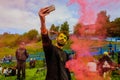 Moscow, Russia - June 3, 2017: Man makes selfie in epicenter of colorful explosion pink powder at Holi Colors Festival Royalty Free Stock Photo