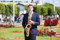 New Life Brass band, wind musical instrument player, orchestra performs music concert, handsome musician man plays on saxophone