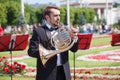 New Life Brass band, wind musical instruments player, orchestra performs music, man musician in black suit plays French horn