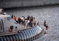 People at the stern of a pleasure boat on the Moscow River