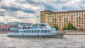 Moscow, Russia - June 21, 2018: Pleasure boat with tourists floating on a background of bridge over Moskva river on a summer day Royalty Free Stock Photo