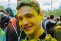 Moscow, Russia - June 3, 2017: Portrait of smiling teenage boy in yellow paint at summer Holly Colors Festival