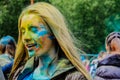 Moscow, Russia - June 3, 2017: Portrait of young blonde girl, powdered different colors at paints festival Holi