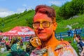 Moscow, Russia - June 3, 2017: Portrait of young hipster-boy in glasses after a colorful headshot at Holi color festival