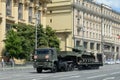 Russian truck tractor KAMAZ-65225 with a Soviet t-34-85 tank on a semi-trailer goes down the street of Moscow after the Victory pa