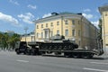 Russian truck tractor KAMAZ-65225 with a Soviet t-34-85 tank on a semi-trailer goes down the street of Moscow after the Victory pa