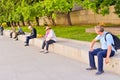 Moscow, Russia, June 11, 2017. Senior tourists and other men sitting outdoors in the city