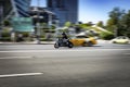 Side view of man in helmet riding BMW M1000RR motorbike on city road Royalty Free Stock Photo