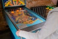 Woman gamer hands playing soviet retro arcade pinball machine game