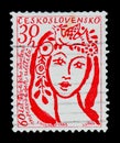 MOSCOW, RUSSIA - JUNE 20, 2017: A stamp printed in Czechoslovakia shows singing girl with bird on head, 60th anniv. of founding M