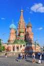 Moscow, Russia - June 28, 2018: Tourists take a photo against St. Basils Cathedral on Red square in Moscow on a sunny summer eveni Royalty Free Stock Photo