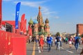 Moscow, Russia - June 28, 2018: Tourists walking near Football Park on Red square on a background of St. Basil`s Cathedral in sunn Royalty Free Stock Photo