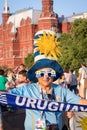 Uruguayan sport fan holding flag and country name on the red square Royalty Free Stock Photo