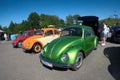 Moscow, Russia - June 01, 2019: Volkswagen beetle Kaefer  parked in row on the open parking on the street. Green, orange and red Royalty Free Stock Photo