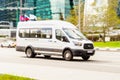 White Ford Transit van vehicle on city road. Fast moving car in Presnenskaya naberezhnaya street. Passenger van is fast transport Royalty Free Stock Photo