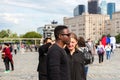 Young interracial couple of students in the city square in the summer .