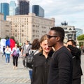 Young interracial couple of students in the city square in the summer