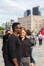 Young interracial couple of students in the city square in the summer