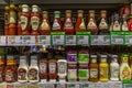 Moscow, Russia, 05/15/2020: Large selection of sauces in banks on shelves in a supermarket. Front view