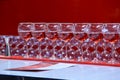 Lined up on the bar, transparent glasses with a red martini Royalty Free Stock Photo