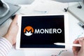 Moscow Russia 20.07.2021 Logo of Monero coin in mobile phone. Cryptocurrency XMR token. Trading blockchain platform to buy,sell on