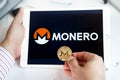 Moscow Russia 20.07.2021 Logo of Monero coin in mobile phone. Cryptocurrency XMR token. Trading blockchain platform to buy,sell on