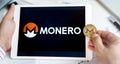 Moscow Russia 20.07.2021 Logo of Monero coin in mobile phone. Cryptocurrency XMR token. Trading blockchain platform to buy,sell on