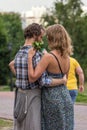 A man hugging his wife in the park. Feelings and emotions of a couple in love. Happy people of the world.