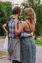 A man hugging his wife in the park. Feelings and emotions of a couple in love. Happy people of the world.