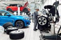 Moscow, Russia, 09.05.2019, a man repairs cars in a car repair shop, many wheels, BMW, tire fitting