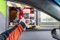 Moscow, Russia, 30/05/2020: A man takes an order from a delivery window to McDonald`s. Drive thru