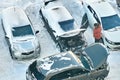 Moscow, Russia, 15-02-2021: Man tries to start up the frozen car engine by using another car and jumper cables Royalty Free Stock Photo