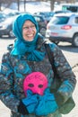 Activist holds the mask, the symbol of Riot on picket to f